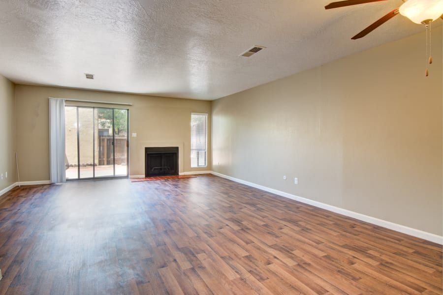 Large living room with a fireplace at Mesa Del Oso in Albuquerque, New Mexico