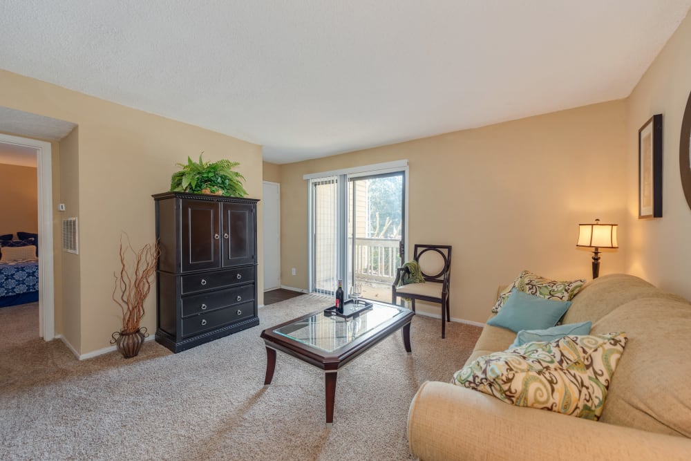 Model living room with door to patio at Aurella Cary in Cary, North Carolina