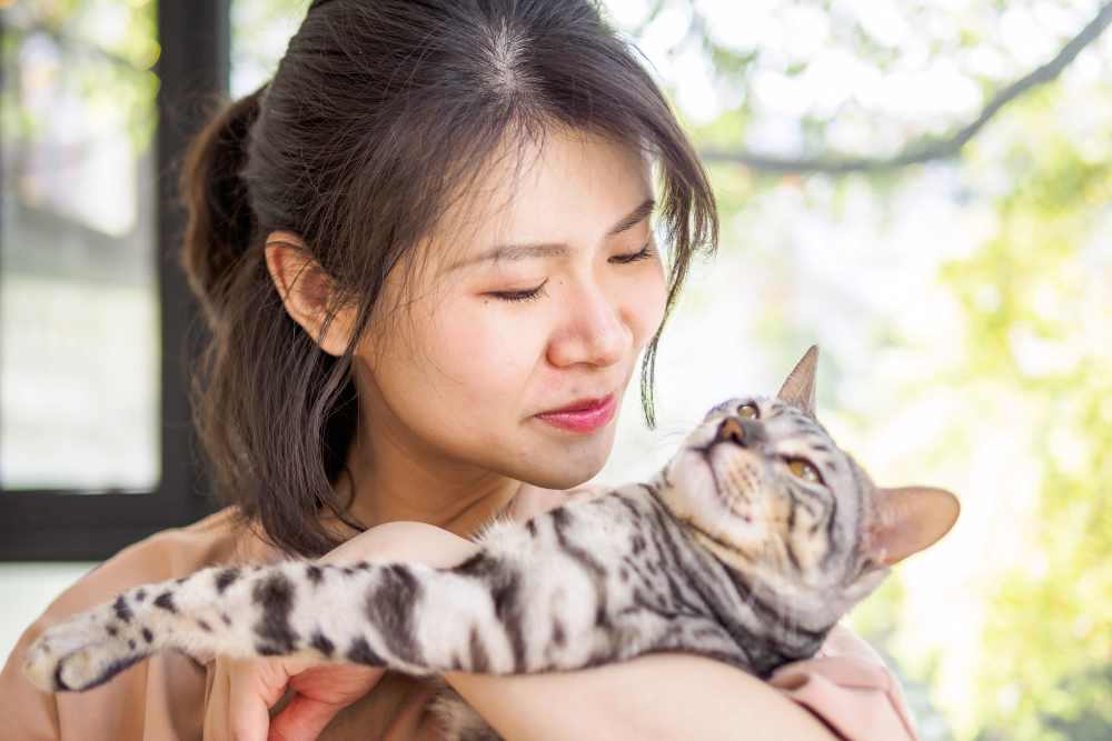 Woman holding her cat at Jewel Lake Villa in Anchorage, Alaska