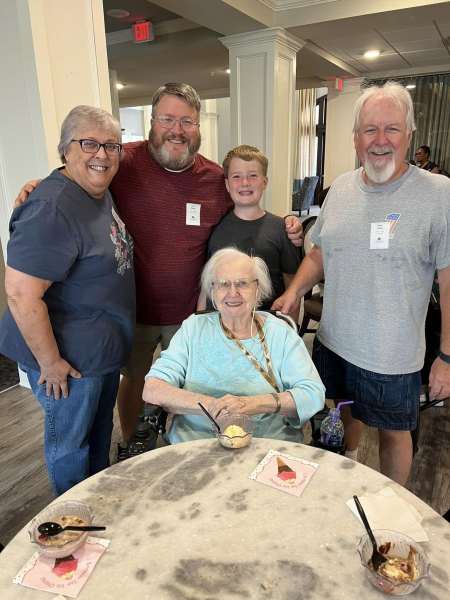 Resident enjoying ice cream with family at The Landing at Watermere Frisco, TX, celebrating connection and community together.