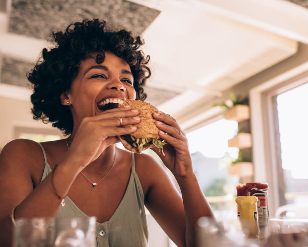 A resident eating a burger near Albany Hill Village in Albany, Georgia