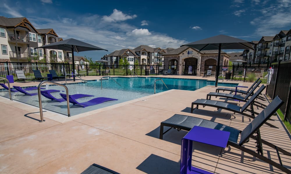Resort-style pool with cabana area at Cedar Ridge in Tulsa, Oklahoma