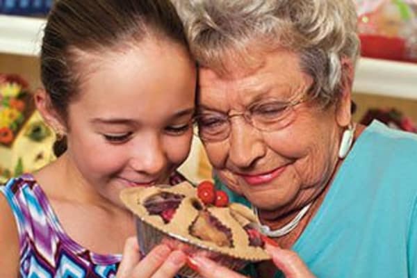 Grandmother and granddaughter share a pie at Discovery Commons At Spring Creek in Garland, Texas