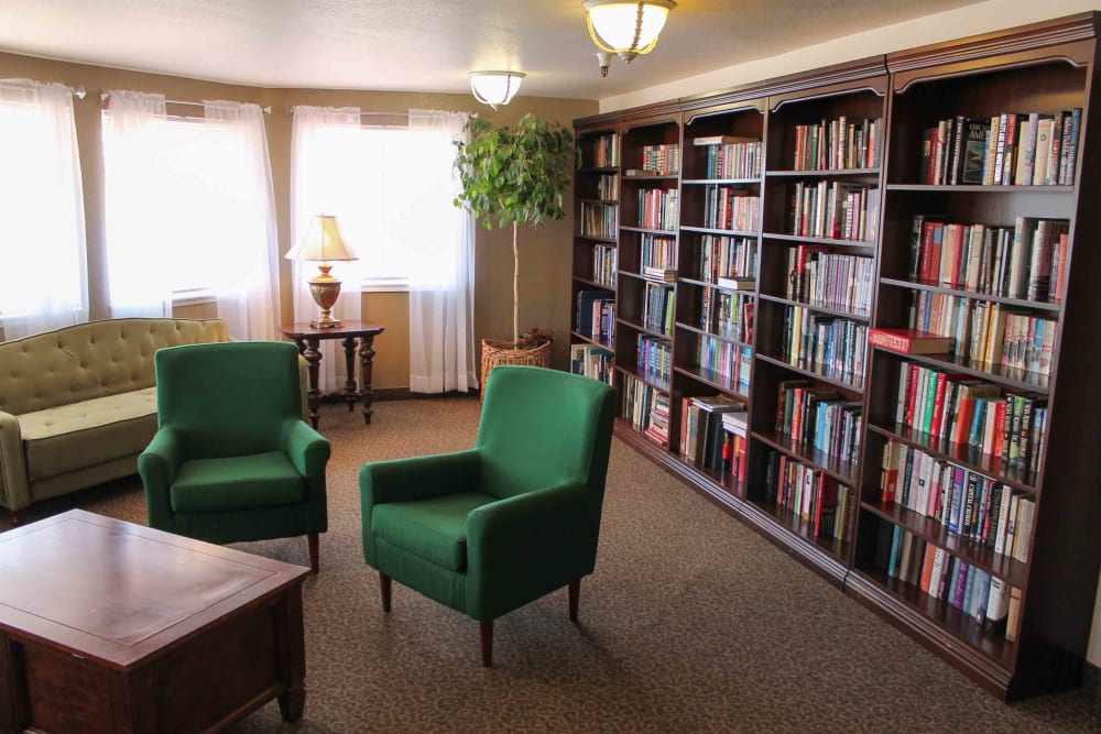 Library with bookshelves and seating area at Truewood by Merrill, Fig Garden in Fresno, California