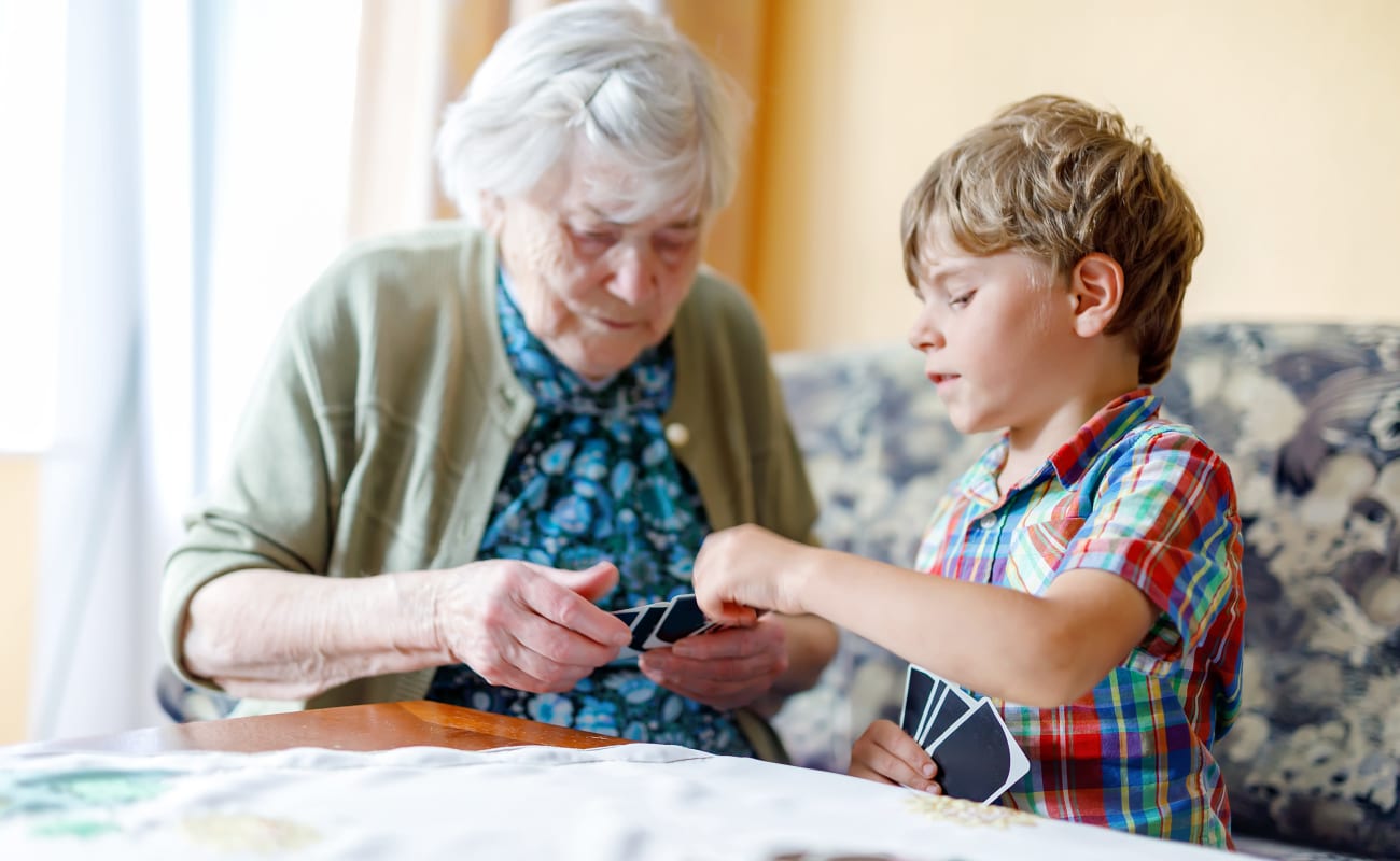 A resident and young boy working playing a game at Truewood by Merrill, First Hill in Seattle, Washington.