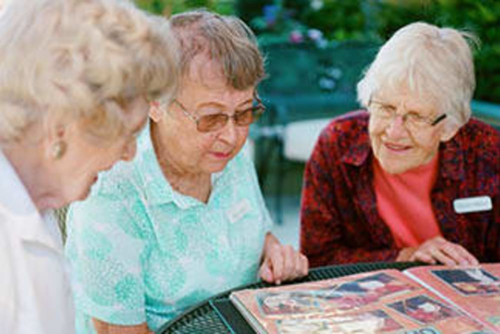 Residents looking through an album at Merrill Gardens.