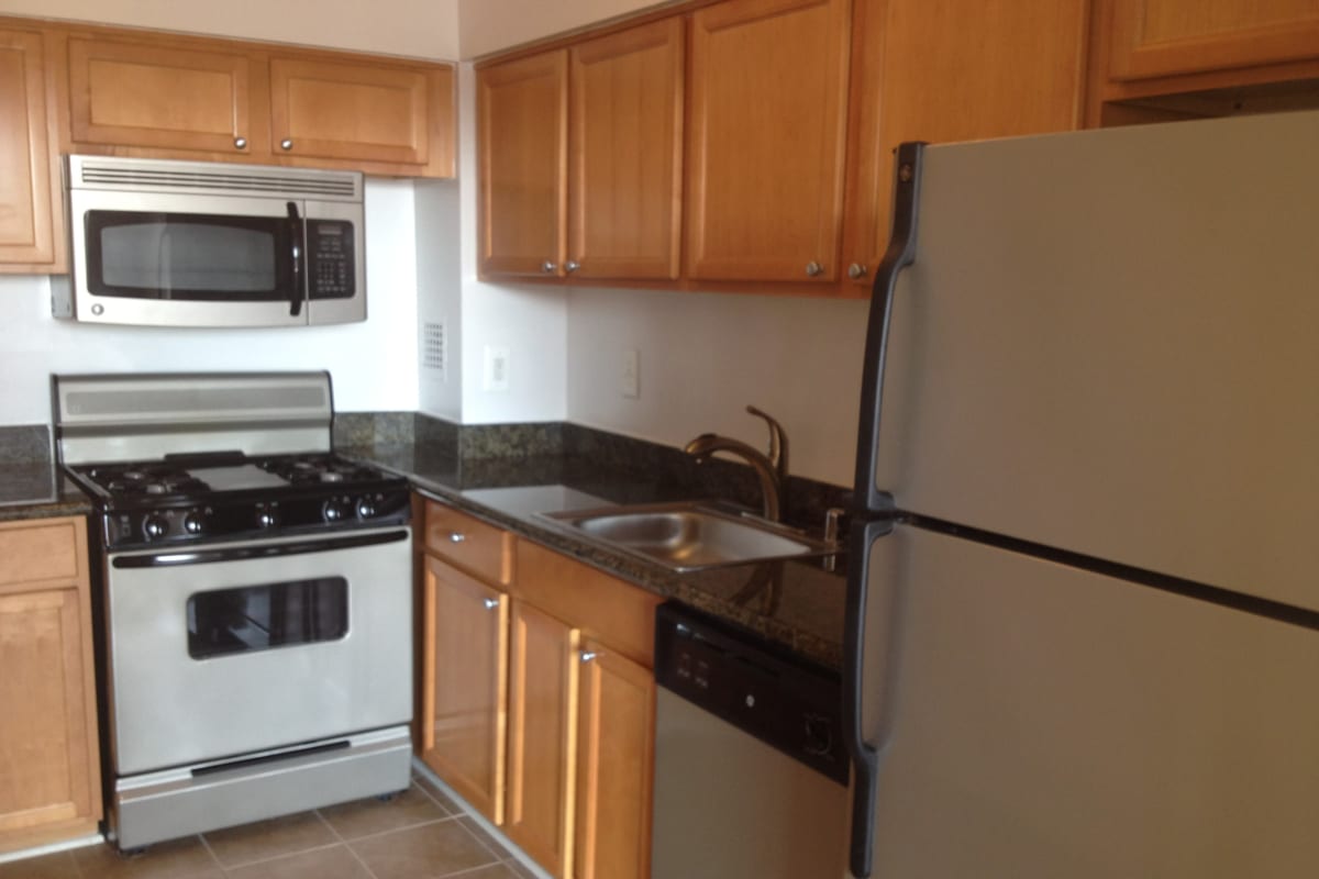 A kitchen with plenty of cabinet space at Bethesda from your living room at Westwood Tower Apartments in Maryland