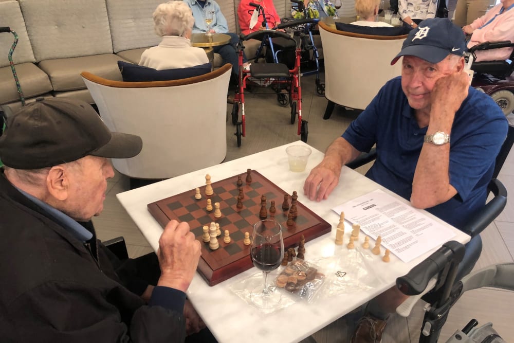 Residents enjoying a chess game together at Anthology of Wildwood in Wildwood, Missouri
