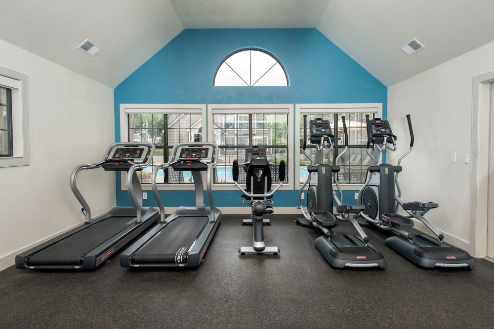 Fitness center with individual workout stations at The Reserve at Capital Center Apartment Homes in Rancho Cordova, California