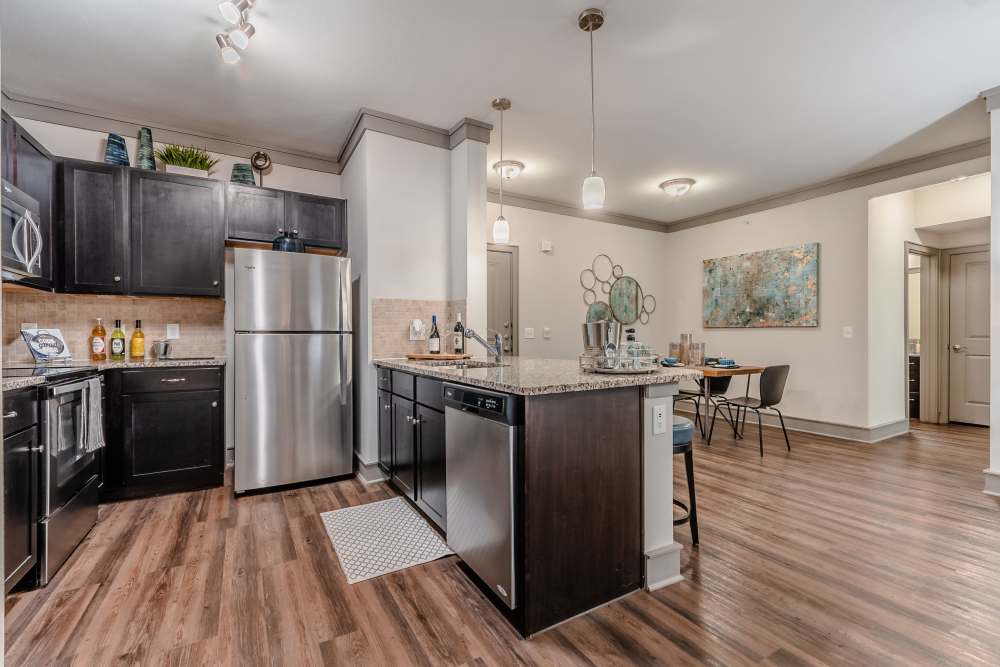 Chef-inspired kitchen with plank style flooring at Anthem Cityline in Richardson, Texas