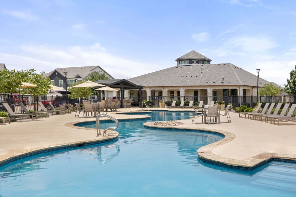 Beautiful resort-style swimming pool area at Olympus Woodbridge in Sachse, Texas