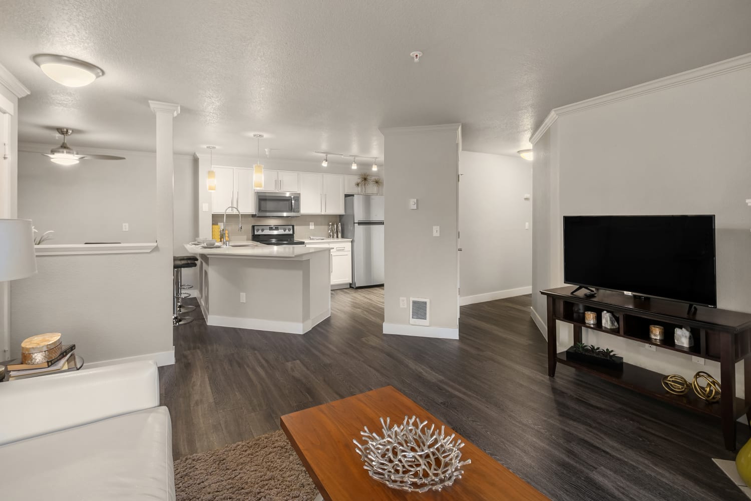 A spacious apartment kitchen and living room at Overlook at Lakemont in Bellevue, Washington
