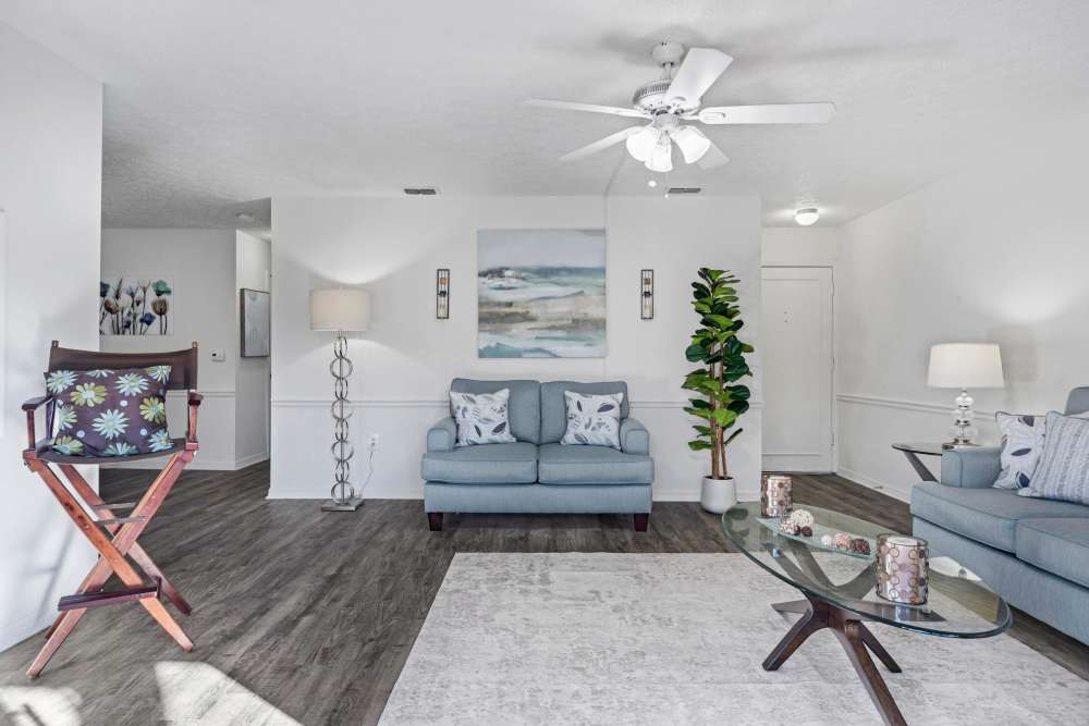Living room with large couch, chair. coffee table and access to patio at Carlton Arms Of South Lakeland in Lakeland, Florida