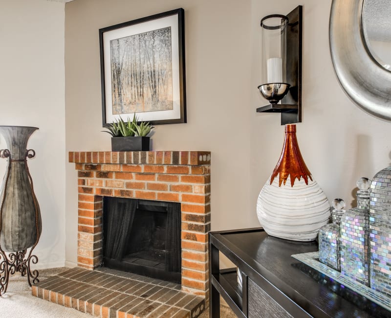 Wood-burning fireplace in a well-decorated model home's living area at Santana Ridge in Denver, Colorado