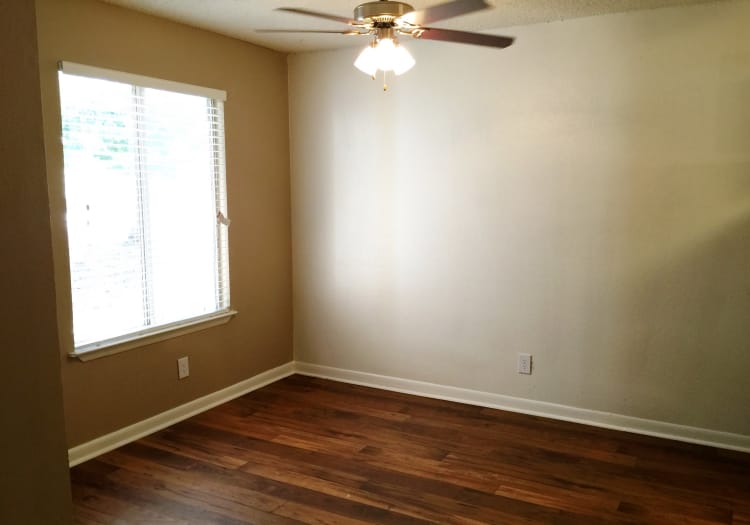 Hardwood floors and ceiling fans in model home at Abbots Glen