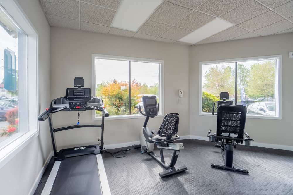 Fitness center with cardio and free weights at Thea Apartments in Tacoma, Washington
