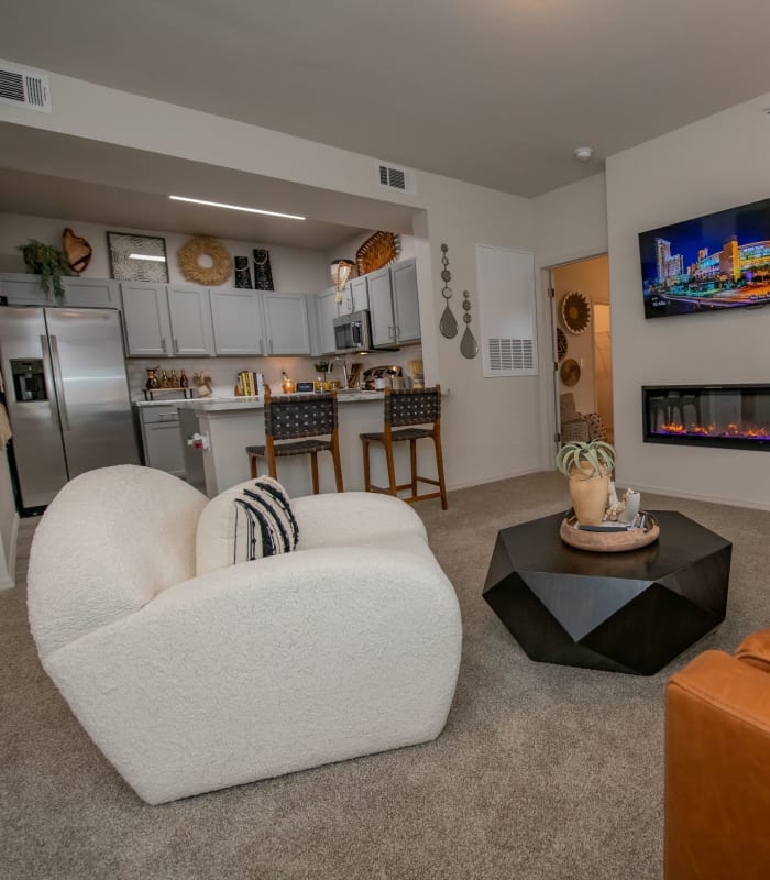 Carpeted living room and kitchen bar at Redbud Ranch Apartments in Broken Arrow, Oklahoma