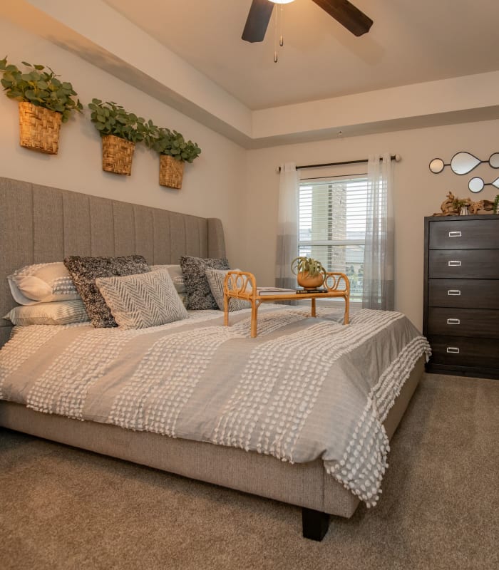 Spacious carpeted bedroom at Redbud Ranch Apartments in Broken Arrow, Oklahoma
