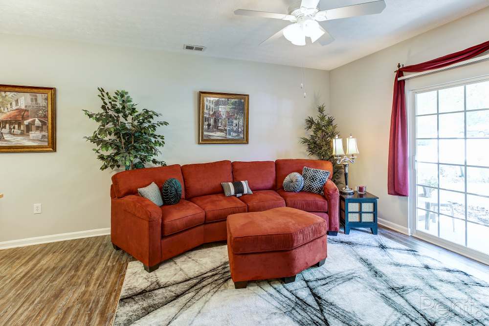 living room with vinyl plank floor and door to balcony