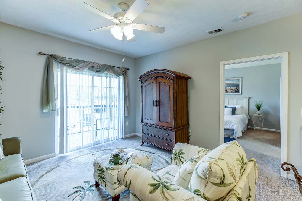 living room with carpeting and door to balcony
