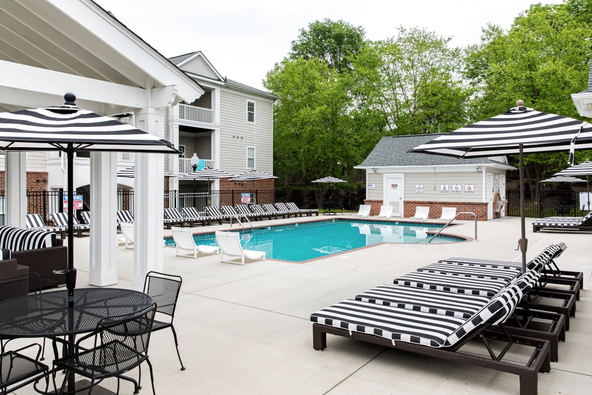 Covered outdoor patio lounge by the swimming pool at University Village in Greensboro, North Carolina