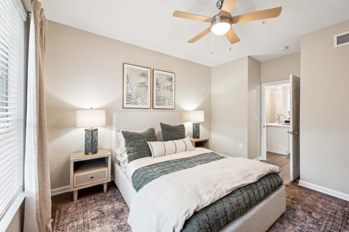 Primary bedroom with a ceiling fan at Preserve at Legacy Park in Lawrenceville, Georgia