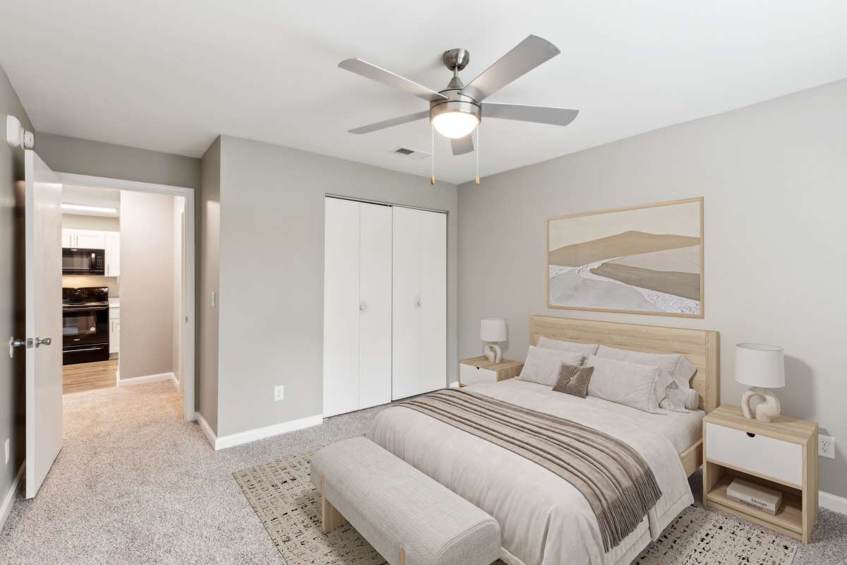 Model bedroom with carpet and ceiling fan at Barrington Parc in Moody, Alabama