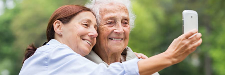 Resident and a caregiver taking a selfie together at Wellington Meadows in Fort Atkinson, Wisconsin