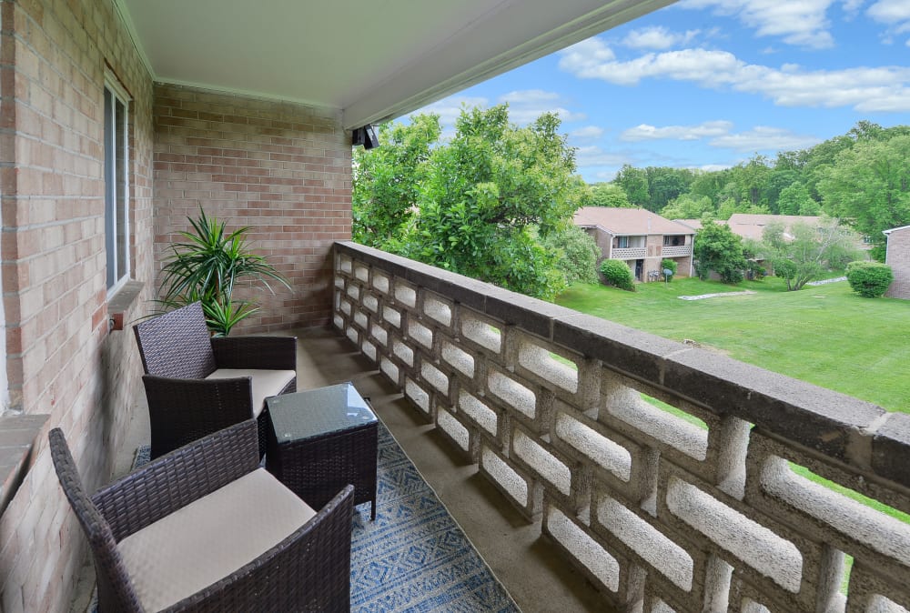 Private balcony overlooking the wooded grounds at Marchwood Apartment Homes