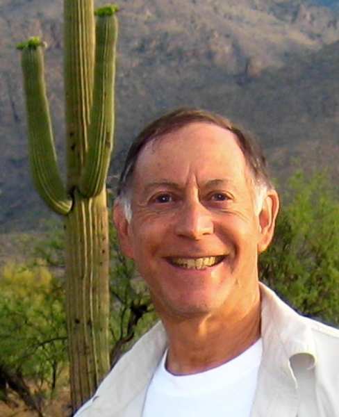 Marc Sbar, a resident at Clearwater Mayo Blvd, smiles outdoors in the Arizona desert with a saguaro cactus in the background.