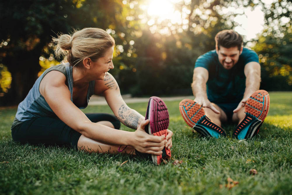 Residents stretching in a park near Celsius Apartment Homes in Charlotte, North Carolina