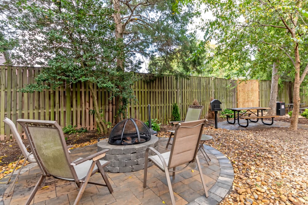 An outdoor patio with a firepit at Manassas Station Apartments in Manassas, Virginia