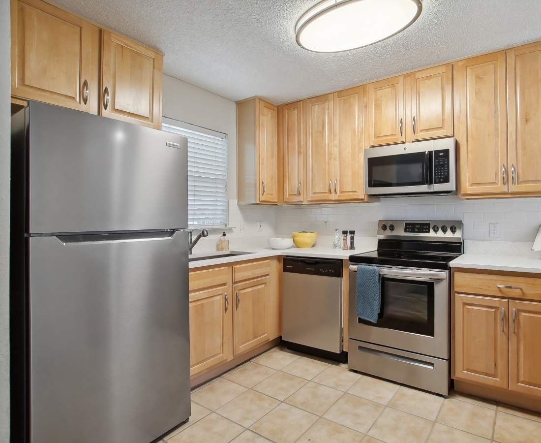 Upgraded kitchen with stainless-steel appliances at The Canopy Apartment Villas in Orlando, Florida