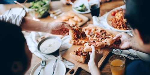 Residents enjoying a pizza feast at their favorite restaurant near MCA #3 Apartments in Los Angeles, California