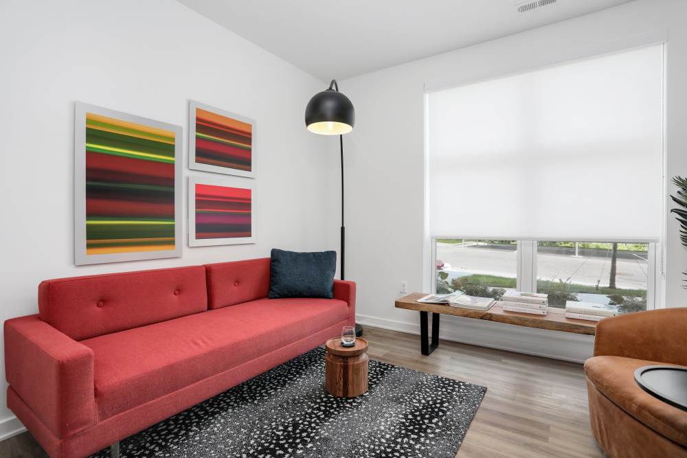 Living room with red sofa set at Innova in Novi, Michigan