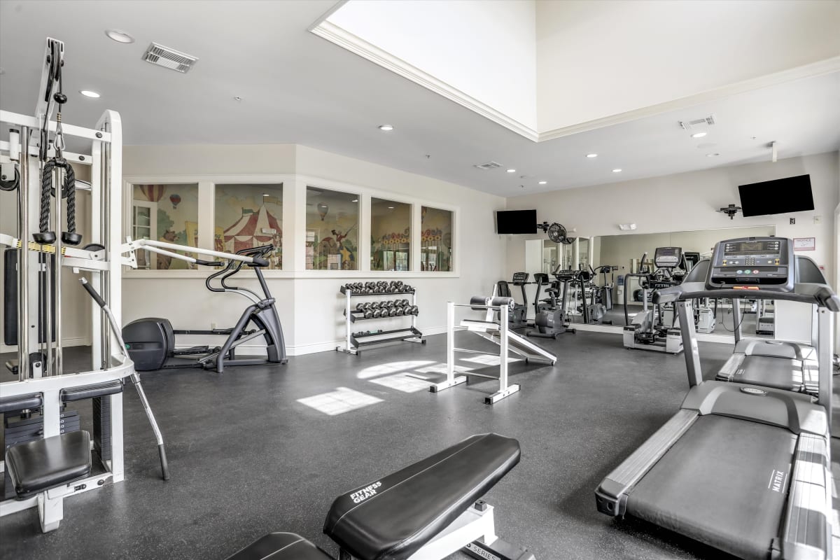 Resident enjoying the modern gym at Central Park Estates in Novi, Michigan