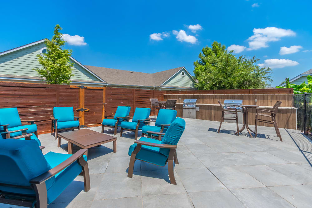 Poolside outdoor grills and seating at Sunstone Village in Denton, Texas.