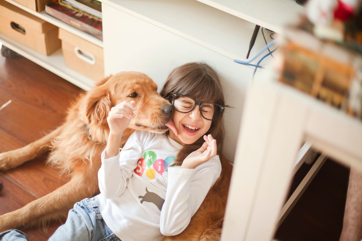 Girl with her dog at Heritage Meadow Apartments in Eugene, Oregon
