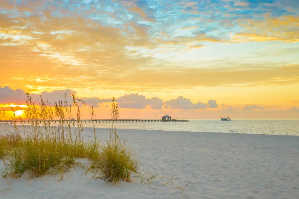 Golden Sunrise Over A Sandy Beach at Grand Biscayne in Biloxi, Mississippi