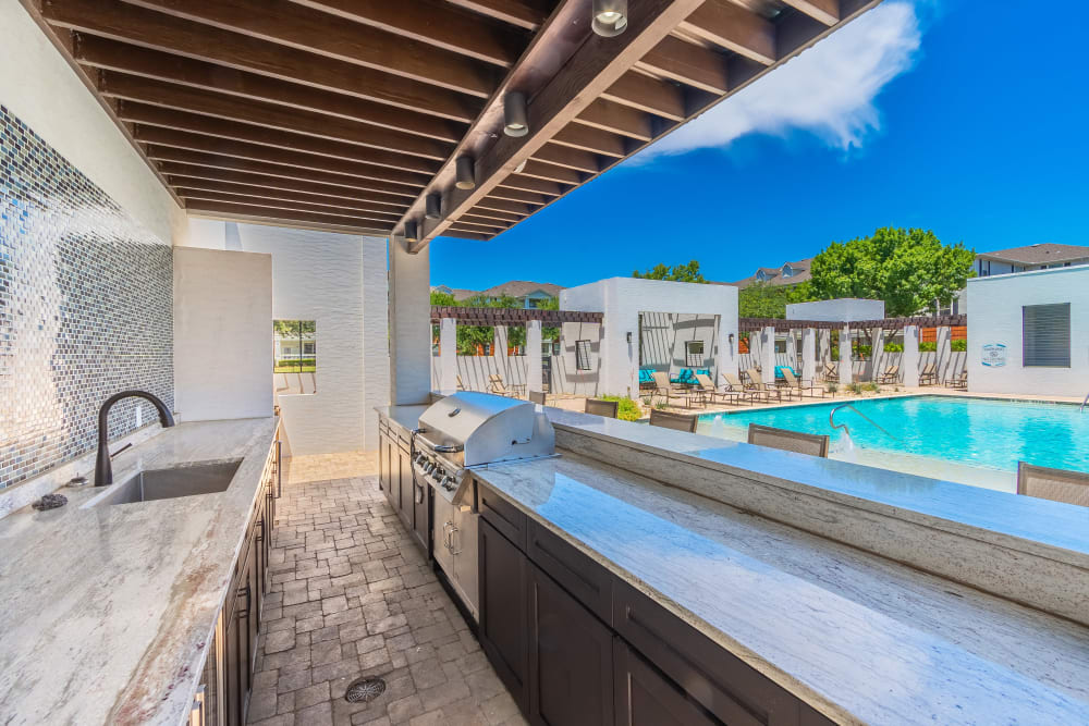Outdoor kitchen poolside at The Spring at Silverton in Fort Worth, Texas.