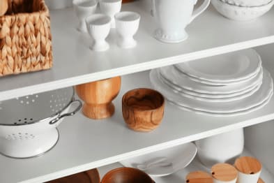 Kitchen shelve with dishes and wood cups