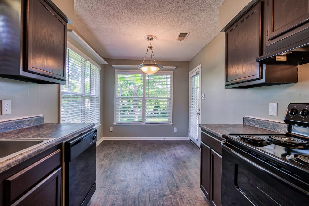 Kitchen with black fridge at The Gatsby at Midtown Apartment Living in Montgomery, Alabama