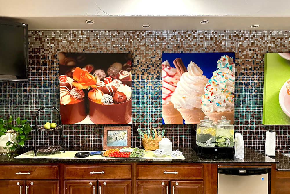 Kitchen counter area adorned with vibrant artwork on the walls creating a lively and dynamic atmosphere
