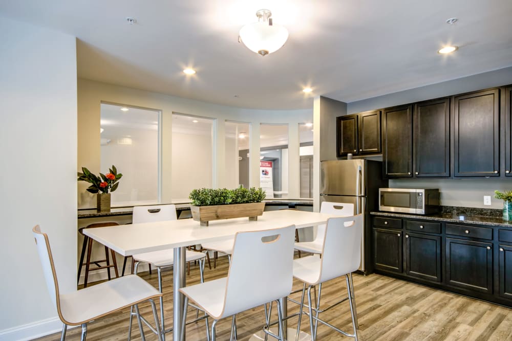 A community  kitchen with a fridge at Manassas Station Apartments in Manassas, Virginia