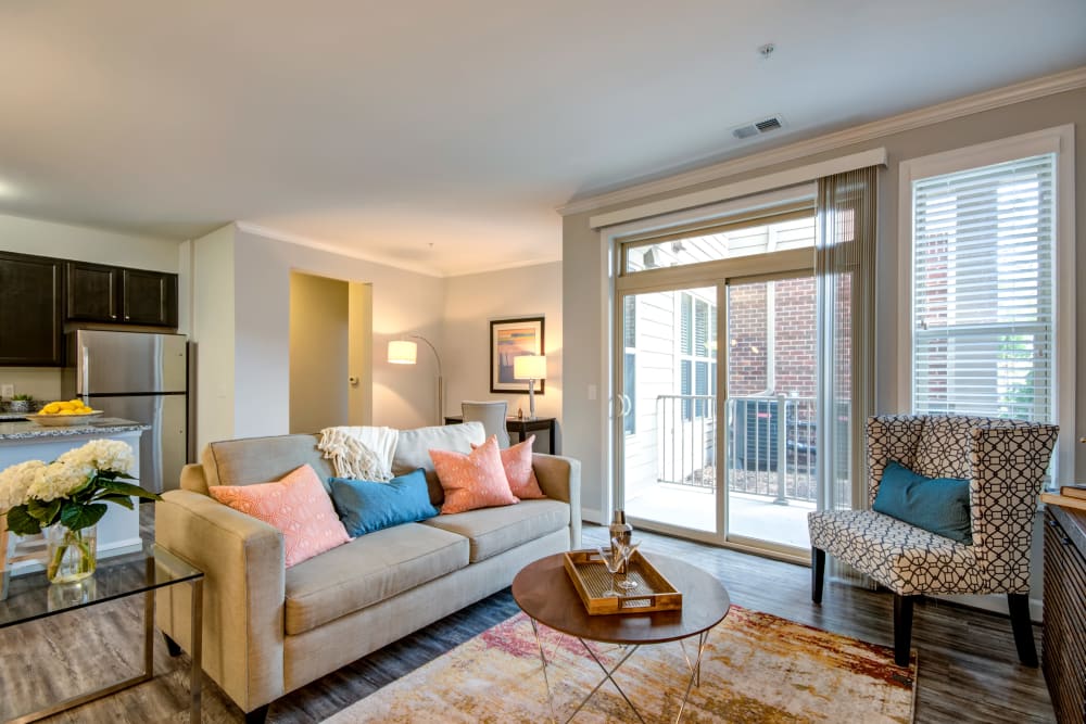 A comfortable living room with patio access at Manassas Station Apartments in Manassas, Virginia