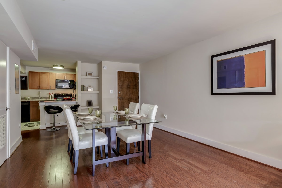 Nice dining room table set for 4 people on the stylish hardwood style floors at Takoma Flats in Washington, District of Columbia
