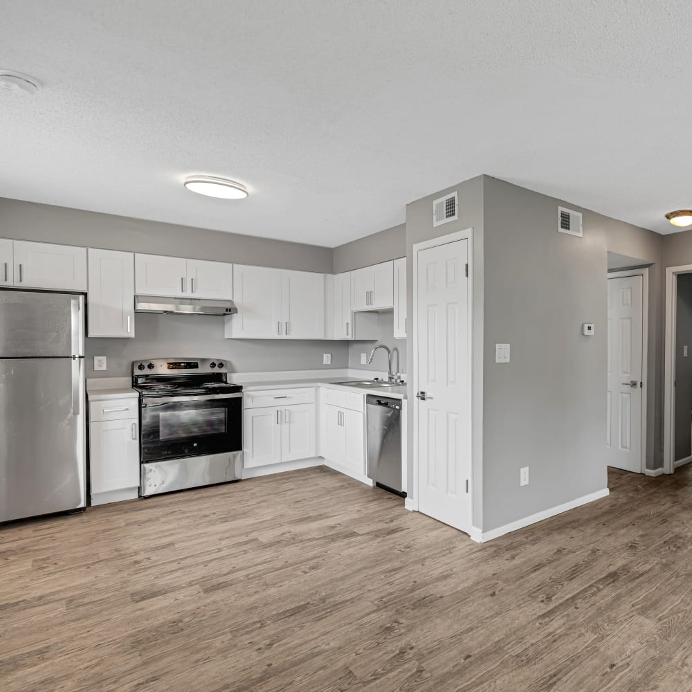 View of hardwood floor and side view of kitchen at The Laurel in Pensacola, Florida