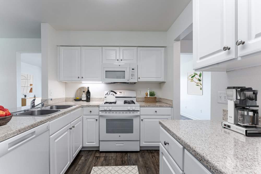 A kitchen with white cabinets in a home at Canyon View in San Diego, California