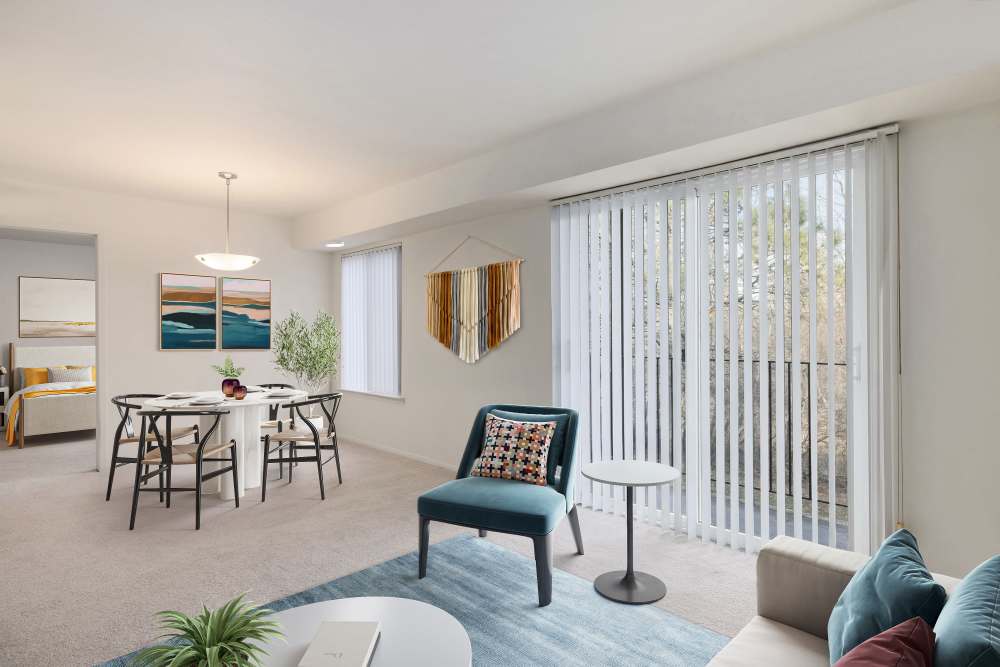 Dining room and kitchen connected to living room of a model apartment at Farmington Oaks Apartments in Farmington, Michigan