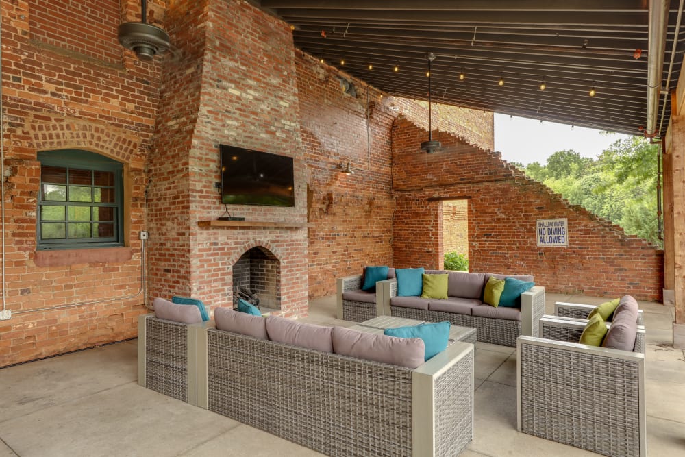 Outdoor seating area with fireplace at The Lofts Of Greenville in Greenville, South Carolina